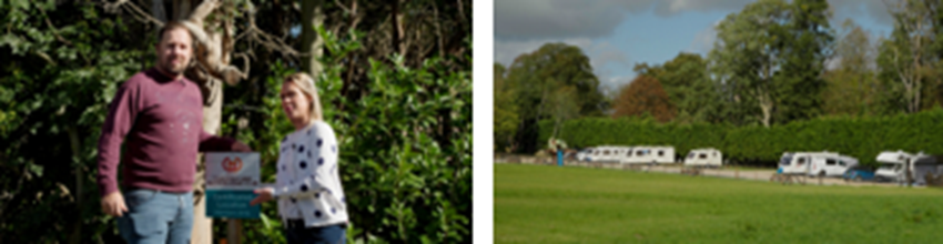 A man and woman standing together, smiling while holding an award in front of a green hedge, representing the Certificated Location of the Year winners.