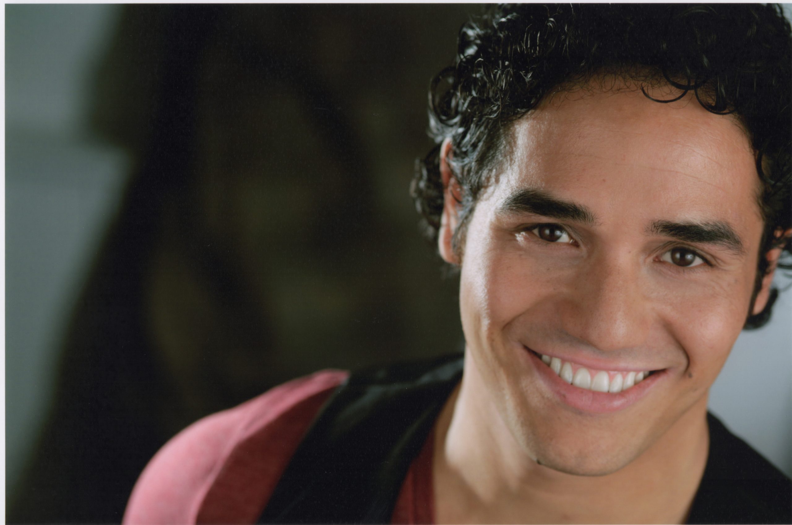 Adam Jacobs in red t-shirt with black vest