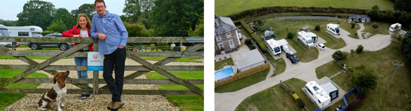 A man and woman standing together by a wooden gate with a dog, smiling at the camera, in a rural campsite setting.