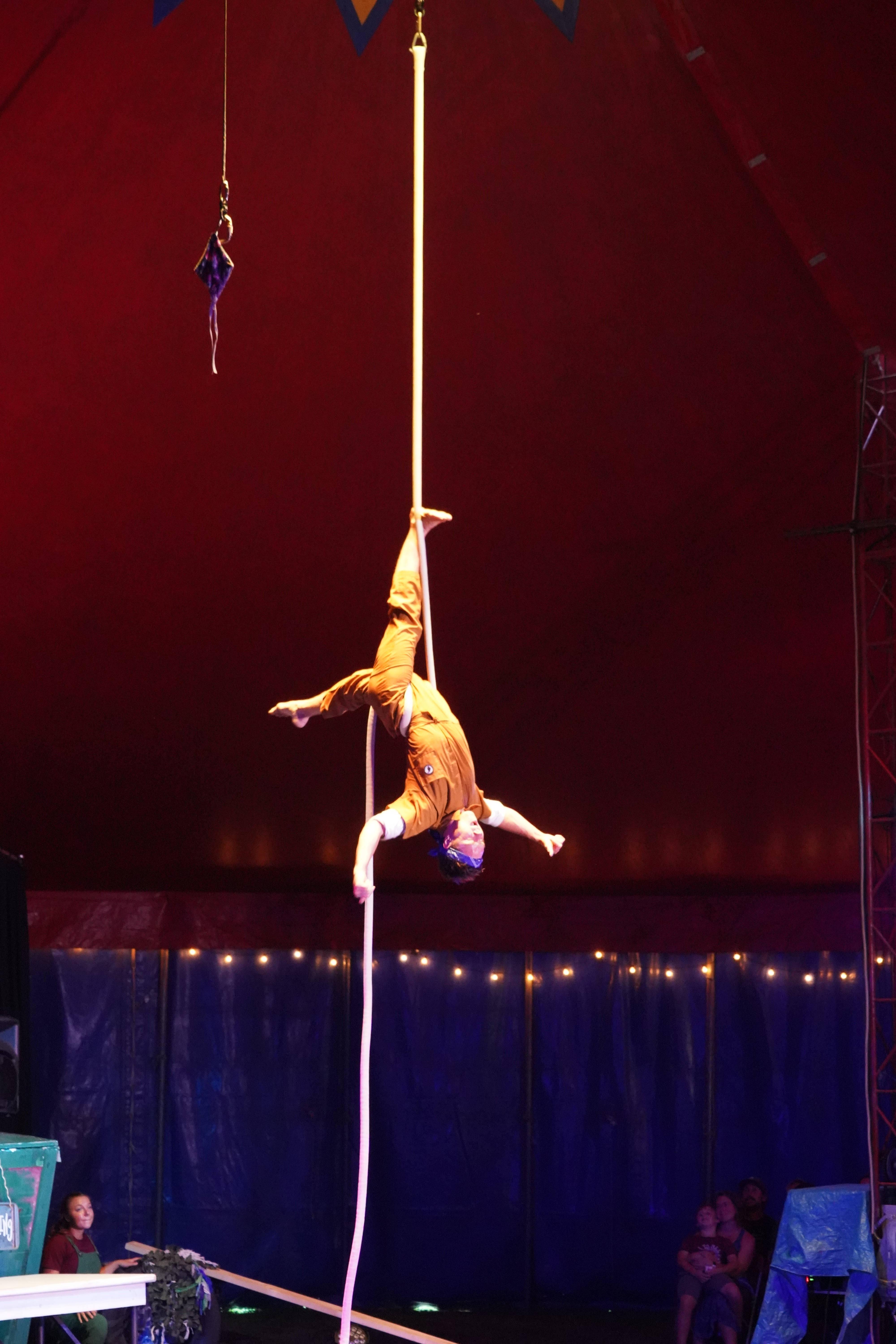 Aerialist upside down under big top tent